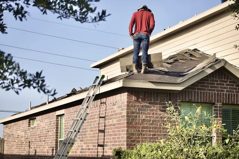 Professional roofer working on a residential roof in Marina Bay